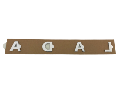 Эмблема L A D A черная задняя на трафарете